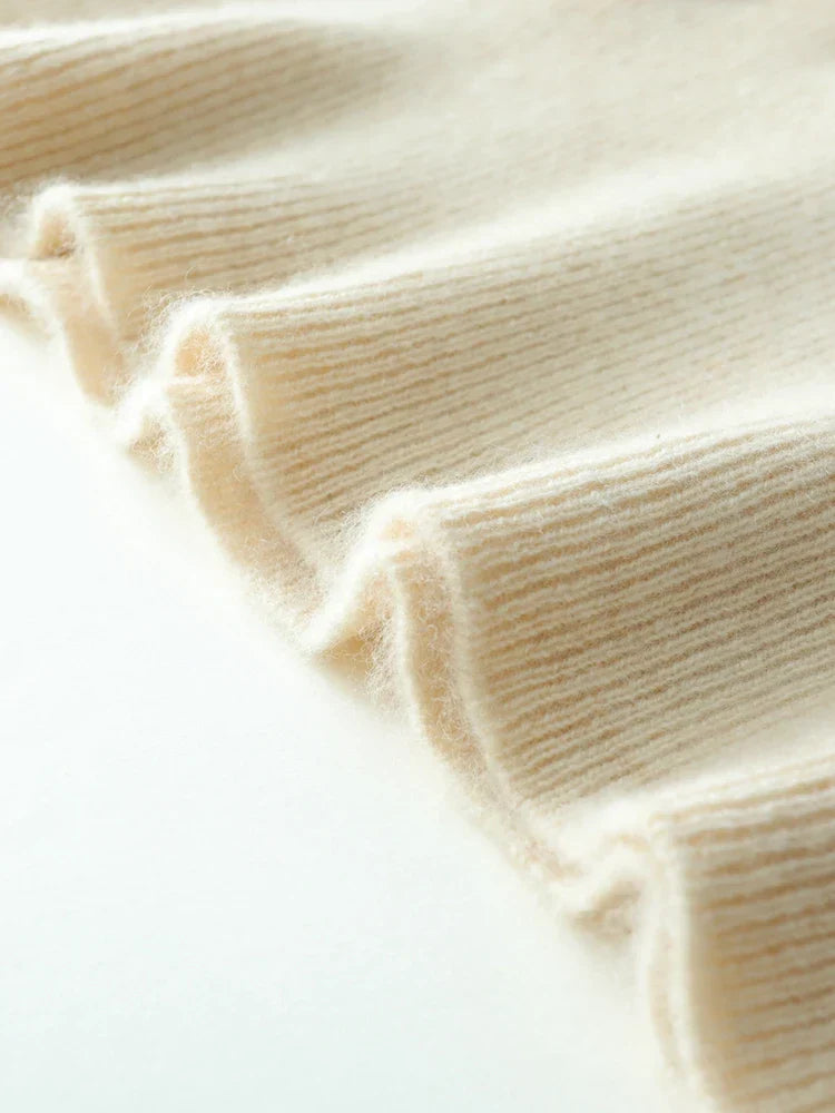 Stylish women's cashmere knit top with a unique crossover design, perfect for any elegant occasion