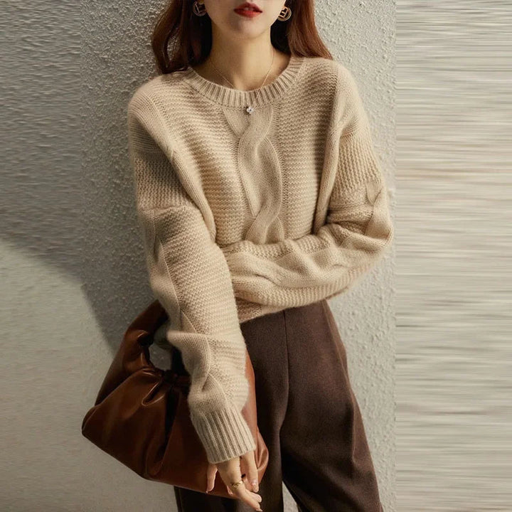 Women's luxurious cashmere blend cable knit pullover in an elegant cream color, perfect for winter fashion