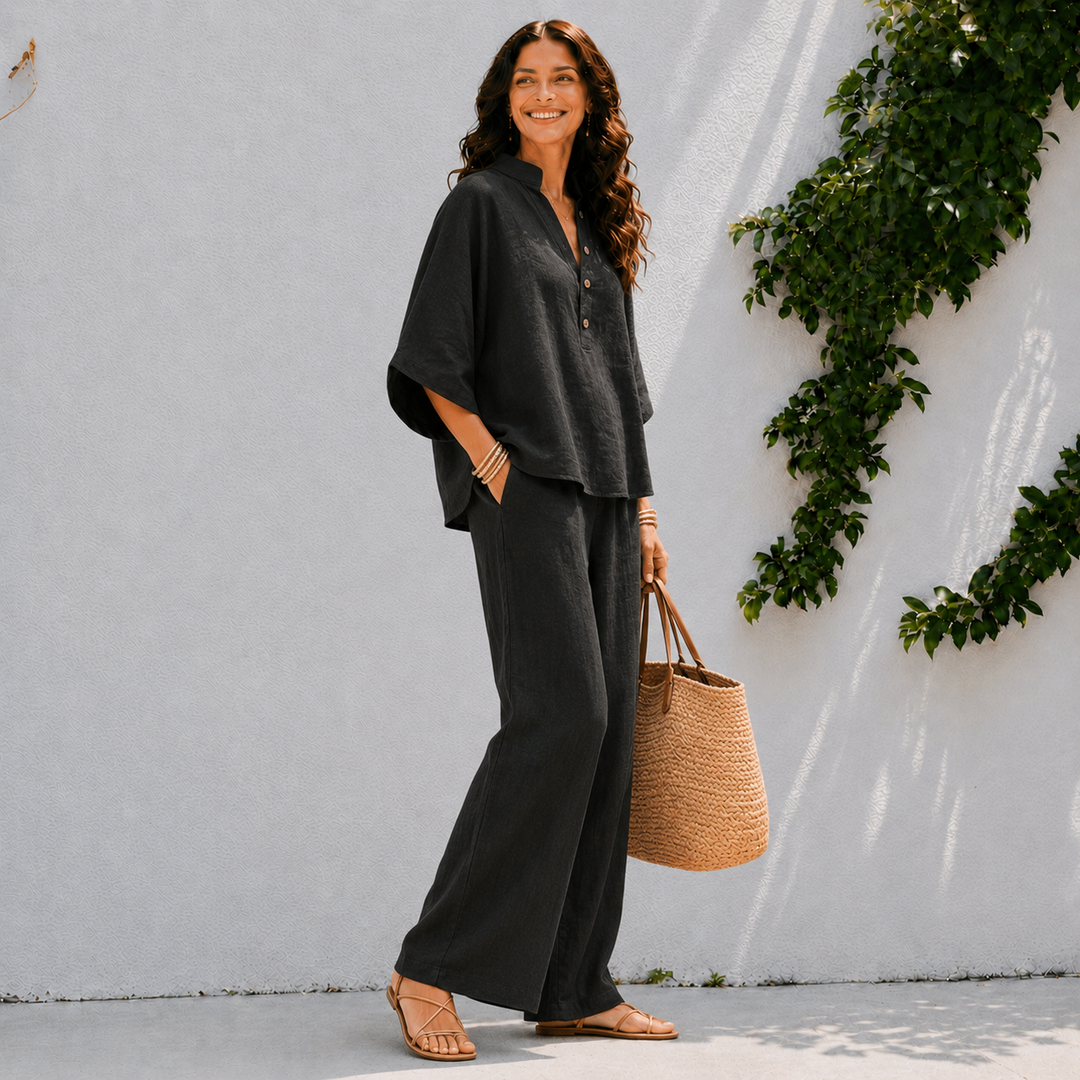 Chic women's vacation outfit: comfortable oversized blouse and wide pants, perfect for summer getaways.