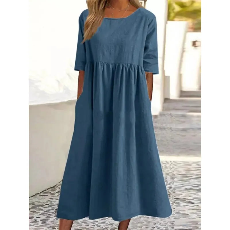 Modest women's long maxi dress with half-sleeves, round neck, & practical pockets.