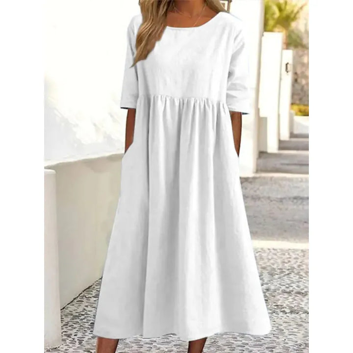 Stylish women's long casual maxi dress featuring half-sleeves, round neck, & convenient pockets.