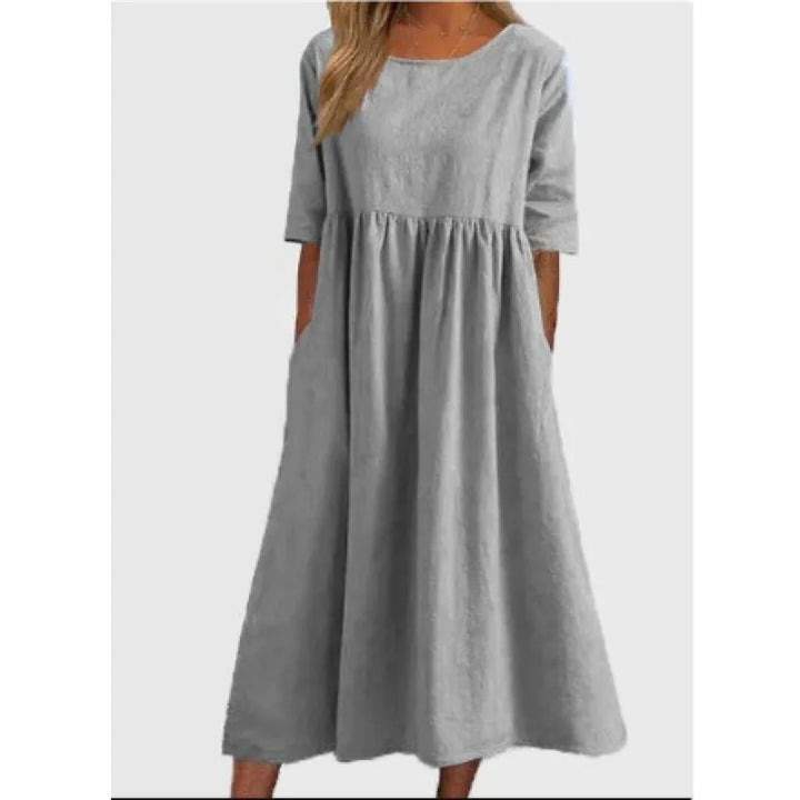 Flowing women's full-length maxi dress with comfortable half-sleeves and side pockets.