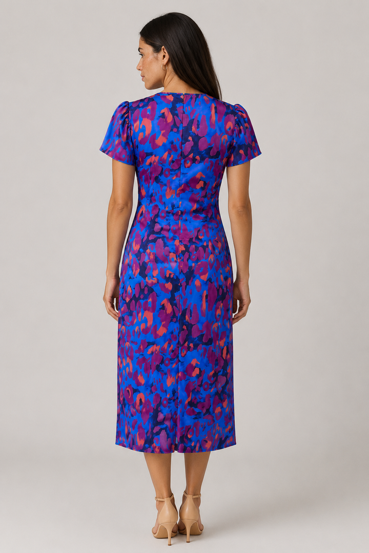 Elegant women's midi dress with puff sleeves, gathered waist, and vibrant abstract print. Flattering summer V-neck.