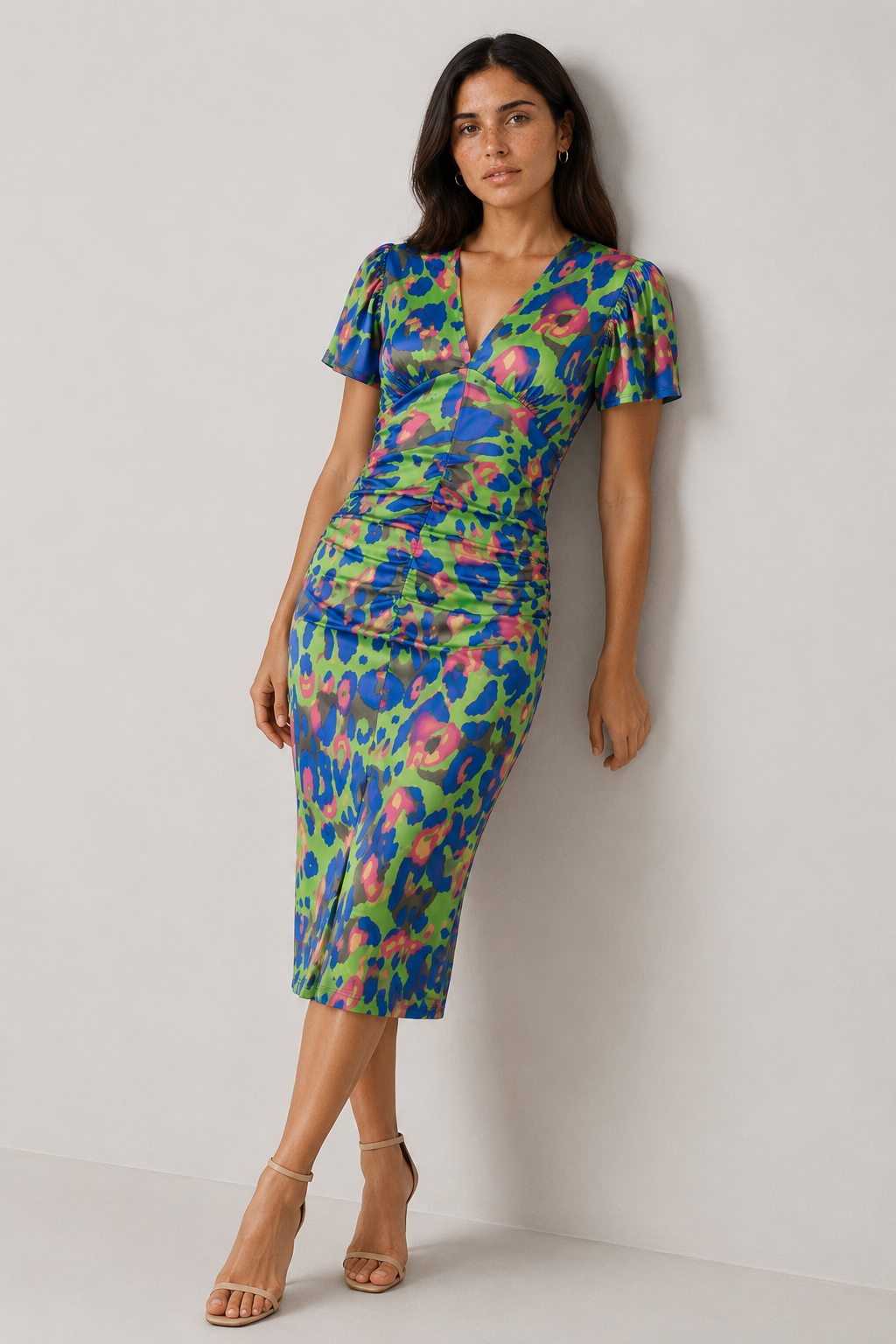 Spring/summer women's midi dress with puff sleeves, gathered waist, and colorful abstract print. Flattering V-neck design.