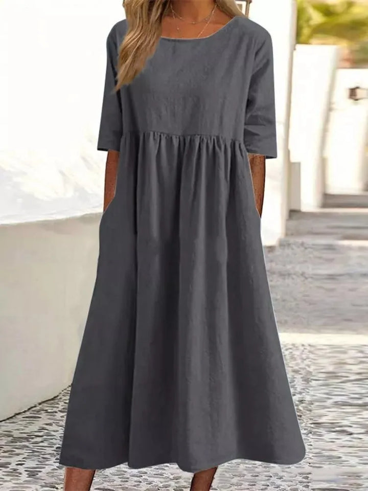 Achieve effortless style with this women's round neck midi dress. Short sleeve, flowy, and comfortable summer dress.