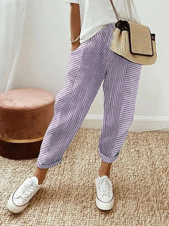 Fashionable women's multi-color striped trousers with elastic waist, relaxed fit for summer comfort.