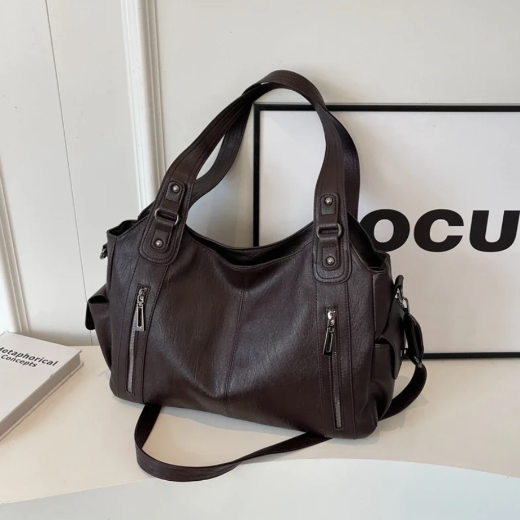Brown women's organized shoulder bag with multi-compartment design. Ideal for daily essentials & sophisticated style.