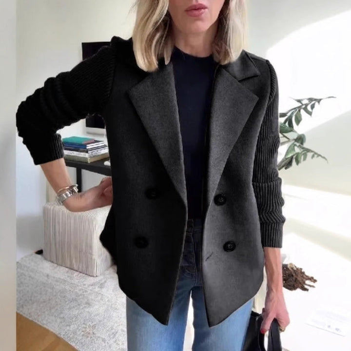 Close-up of the textured stretch knit fabric on a women's sweater blazer, a stylish layering piece.
