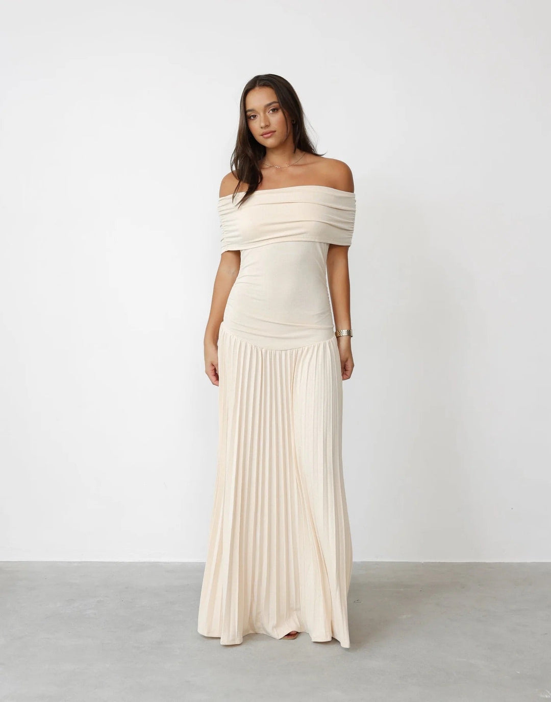 Women's off-shoulder pleated maxi wedding guest dress in elegant cream.