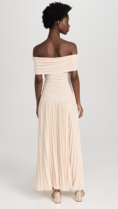 Off-shoulder pleated cream maxi dress, perfect as a wedding guest outfit.