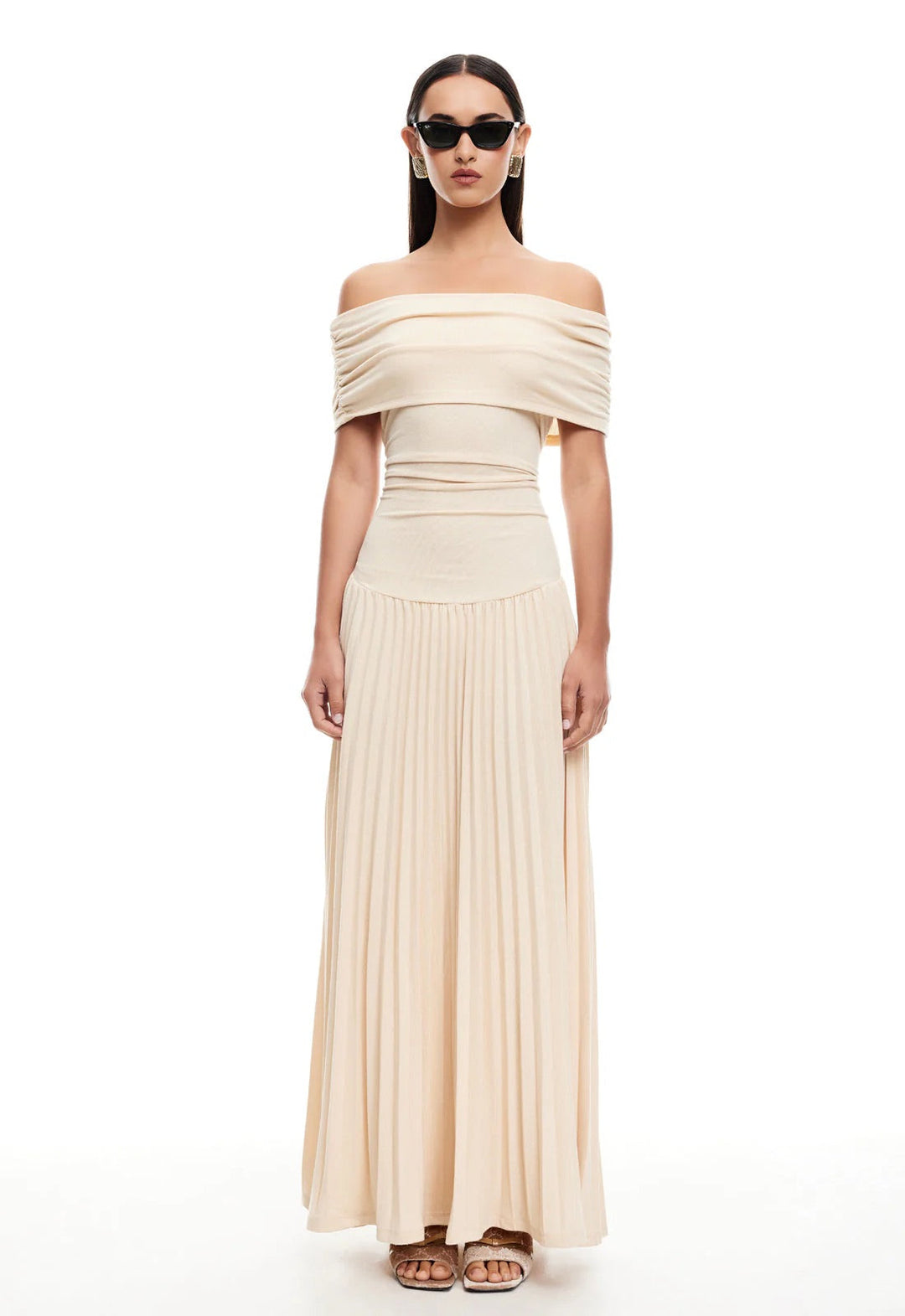 Formal navy off-shoulder pleated maxi dress for elegant wedding attendance.