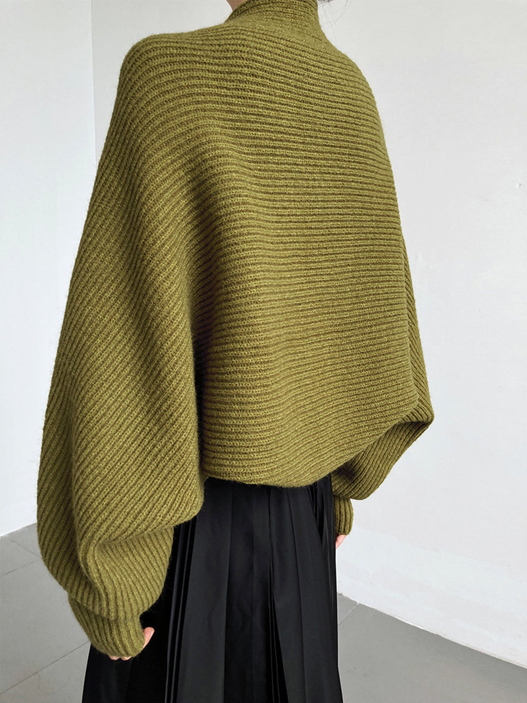 Off-white women's shrug sweater, long sleeve open-front style. Ideal for versatile casual wear.