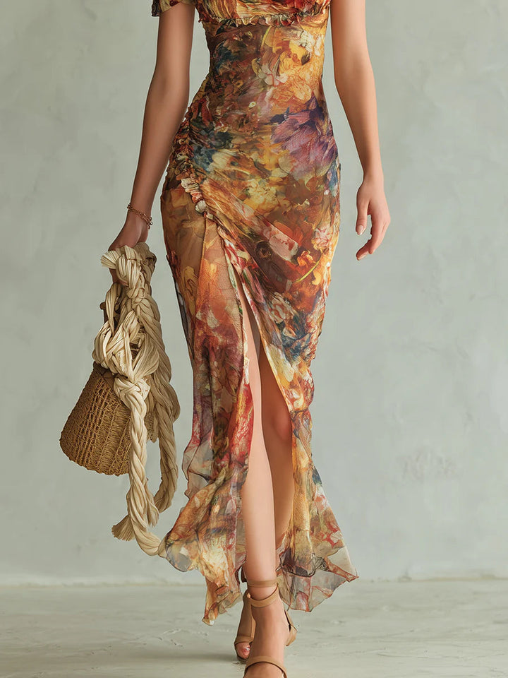 Vibrant orange floral maxi dress for women with a flattering ruffle neckline, sweetheart design, and side slit.
