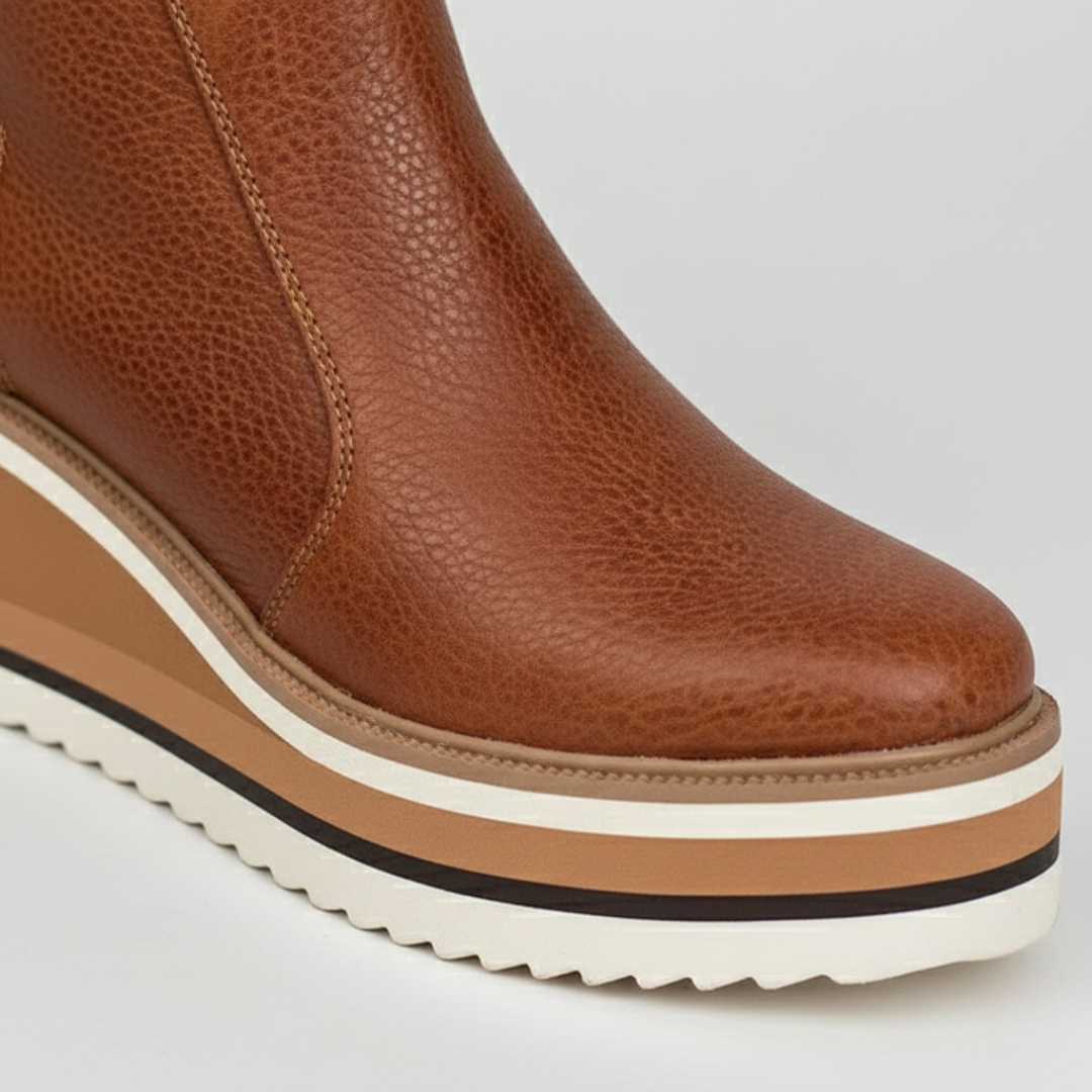 Comfortable women's ankle boots featuring a supportive wedge heel & orthopedic design for all-day wear.