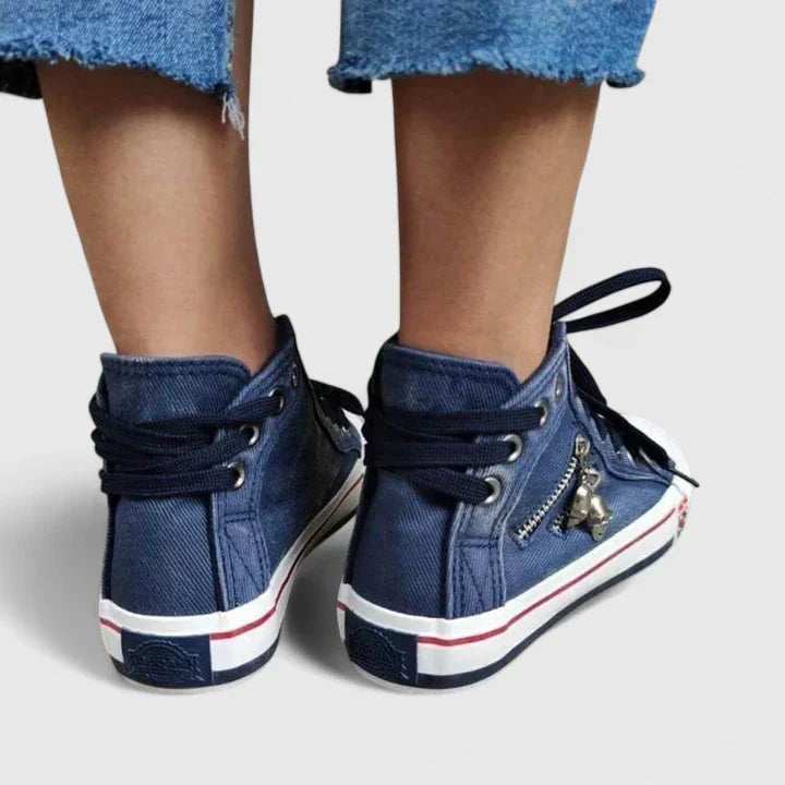 Close-up of navy blue denim orthopedic shoes for women, highlighting arch support & comfortable design.