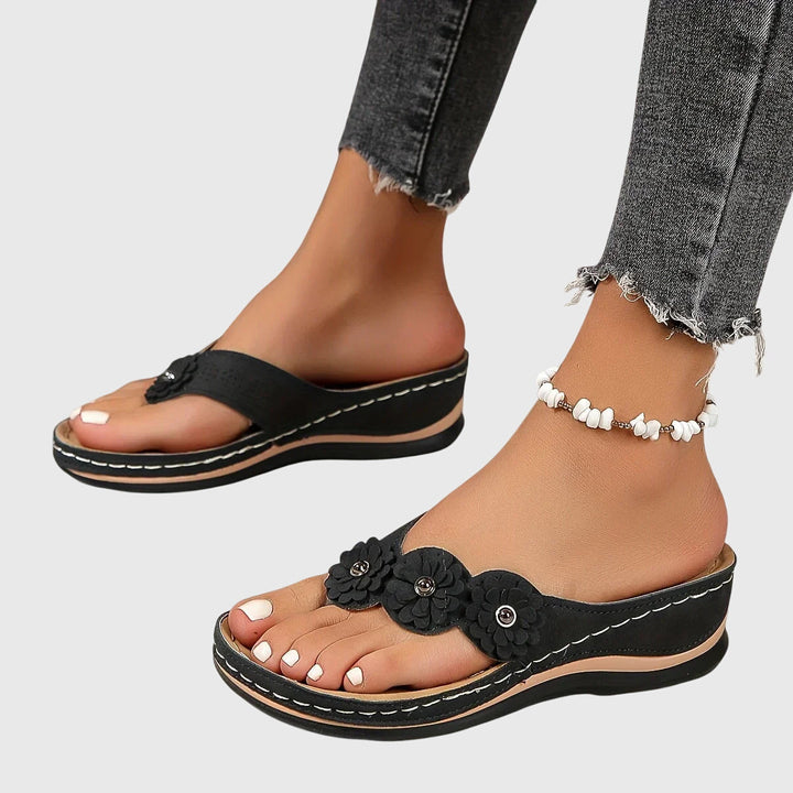 Durable women's flip flops featuring arch support, shock absorption & pain relief.