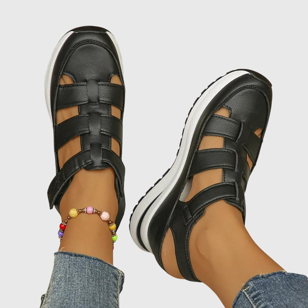 Profile view of women's orthopedic sandals featuring adjustable straps & contoured arch support.