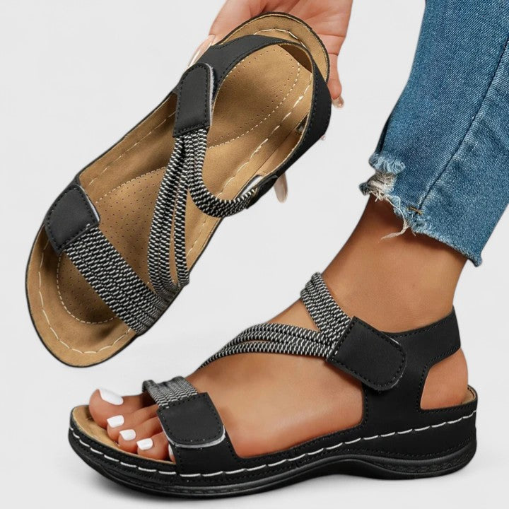 Close-up of women's orthopedic sandals, highlighting the innovative three-arch support technology.