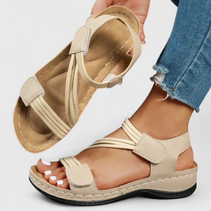 Woman wearing comfortable orthopedic sandals with three-arch support for posture and foot health.