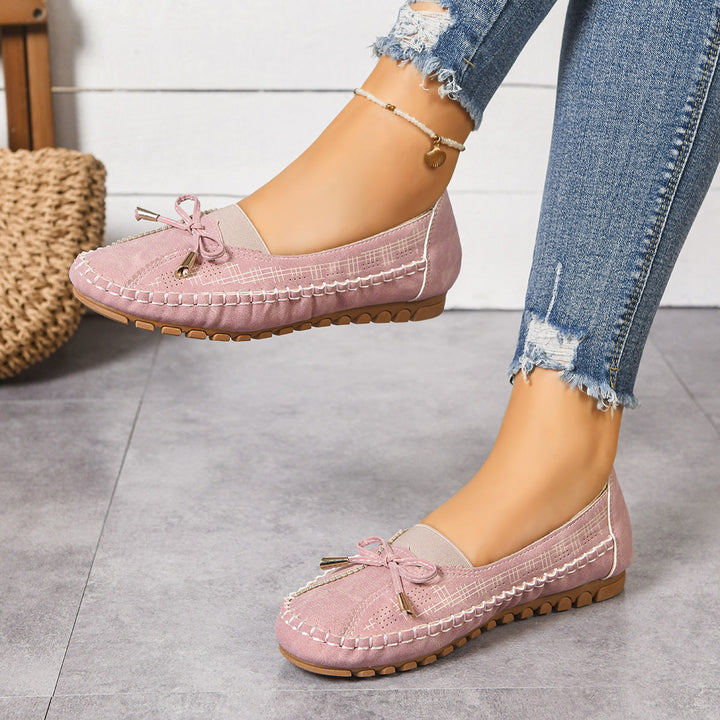 Casual women's slip-on walking shoes, offering cushioned support and a roomy wide fit.