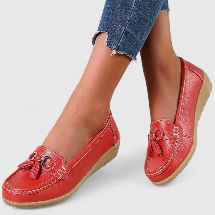 Stylish women's slip-on loafers, featuring moc toe design and arch support for comfort.