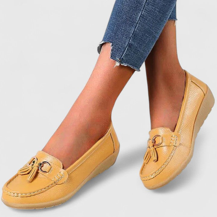 Side view of women's orthopedic slip-on loafers, showing cushioned sole and arch support.