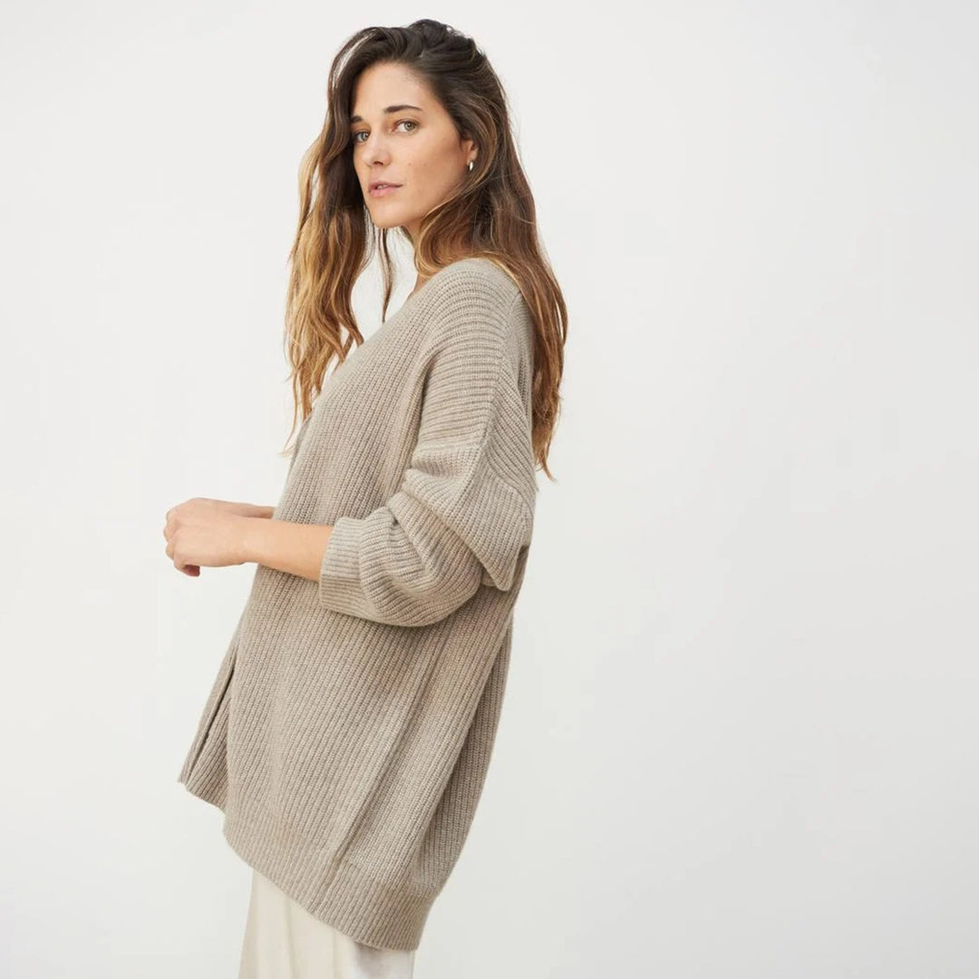 Front view of women's oversized V-neck button-up cardigan, a cozy fall fashion staple.