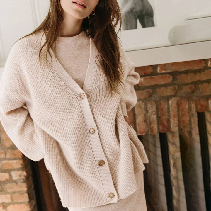 Close-up of the cozy knit texture of the women's oversized button-up V-neck cardigan.