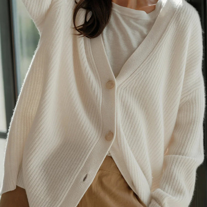 Classic women's button-up cardigan, an oversized cozy knit sweater for elegant winter looks.