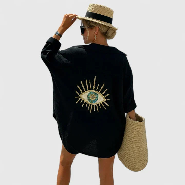 Chic Evil Eye patterned women's oversized button-down shirt, a versatile beach cover-up and statement piece for summer.