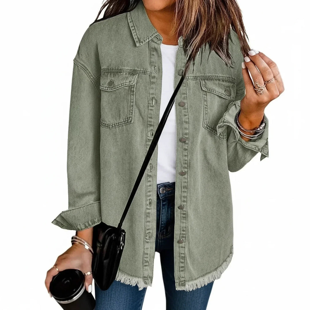 Fashionable women's oversized shirt jacket with fringe hem. Provides relaxed fit and stylish casual outerwear.