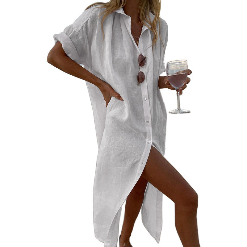 Comfortable oversized beach shirt dress for women with button-down front & roll sleeves, great for seaside lounging.
