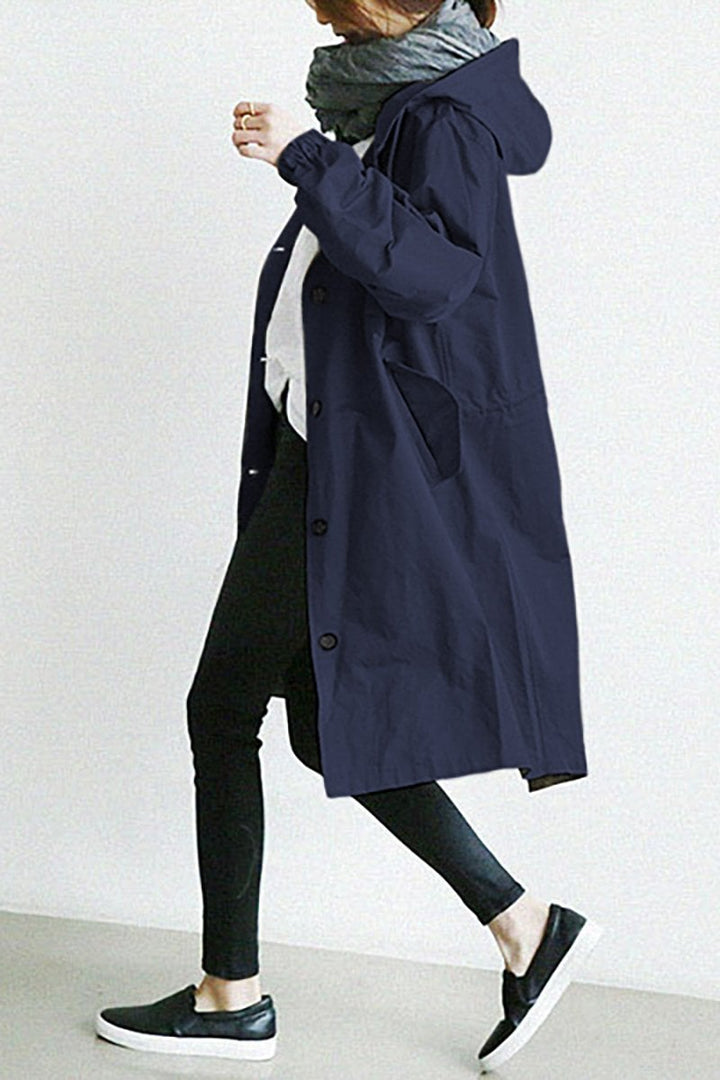 Modern women's oversized trench coat. Durable rain parka for weather protection & stylish outerwear.