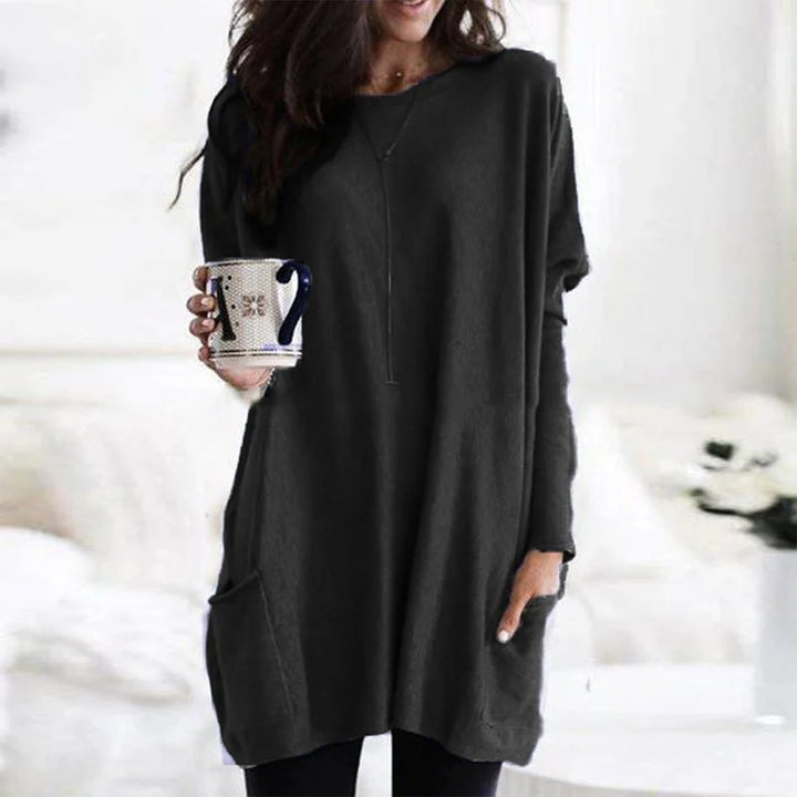 Close-up of women's oversized tunic top showing soft fabric, long sleeves & functional side pockets.