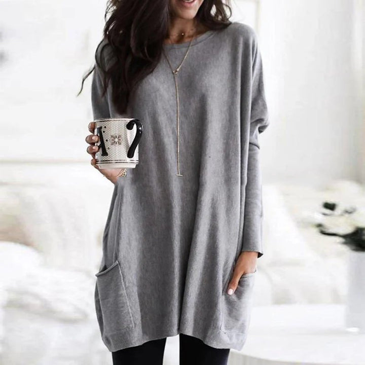 Back view of women's oversized tunic top, highlighting its relaxed fit, long sleeves & comfortable casual style.