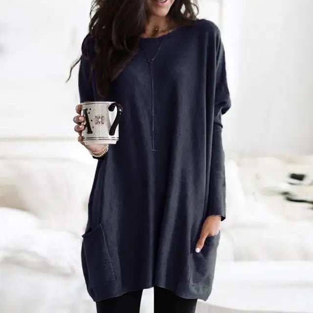 Model wears a women's oversized tunic top with pockets, highlighting its relaxed fit and comfortable casual style.