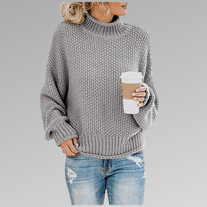 Warm women's chunky knit sweater featuring an oversized fit and a comfortable turtleneck design.