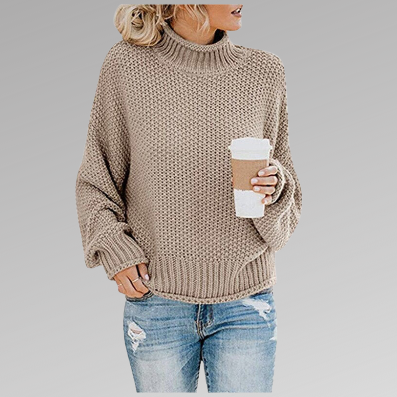 Stylish women's oversized chunky knit sweater, featuring a snug turtleneck for warm winter fashion.