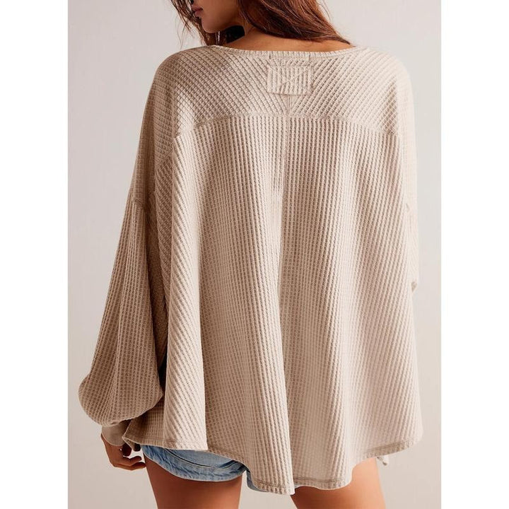 Full view of women's comfortable knit V-neck sweater in a vibrant color, offering an oversized fit