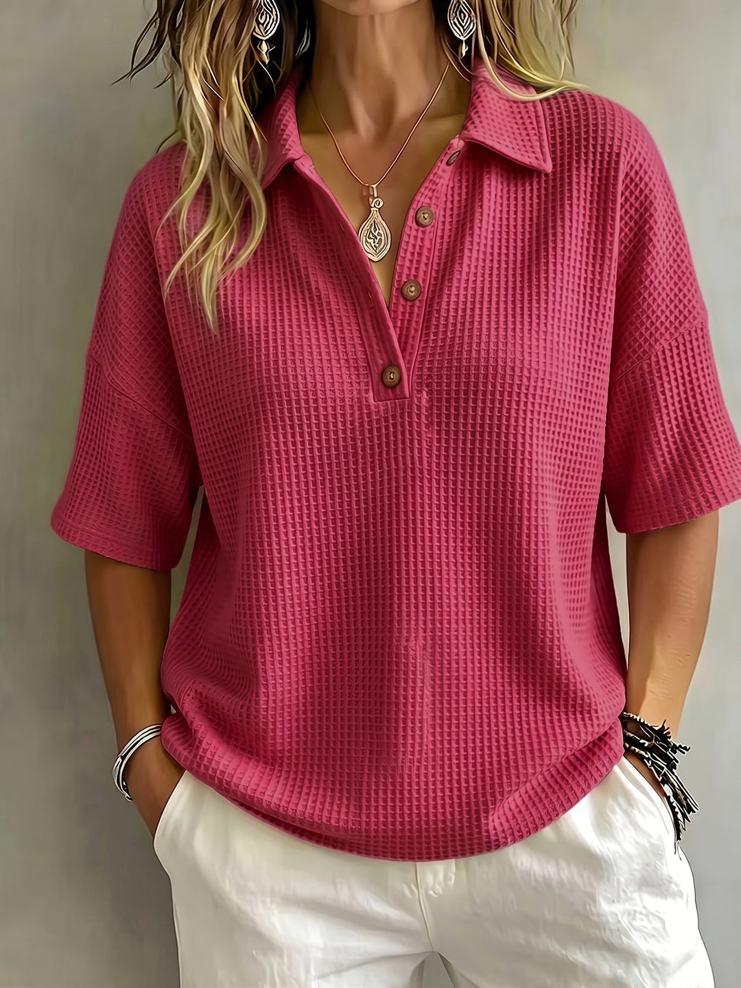 Dropped shoulder women's oversized polo top in a breathable waffle texture.