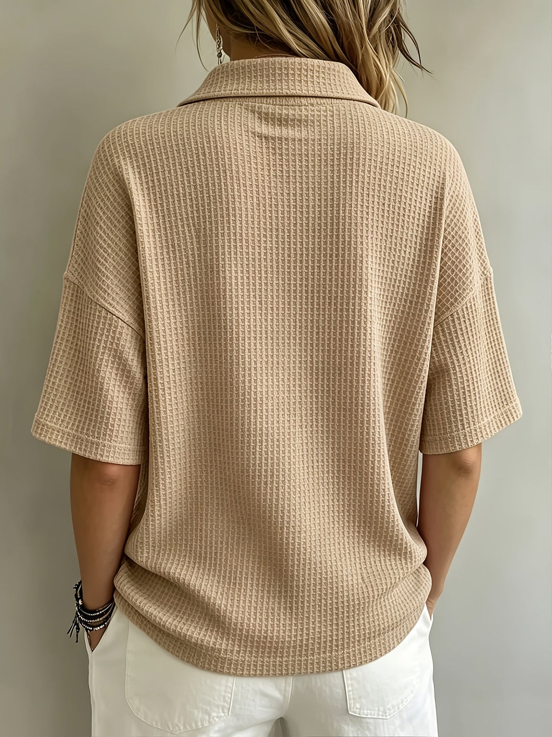 Loose fit women's polo shirt with a stylish waffle texture, dropped shoulders & button detail.