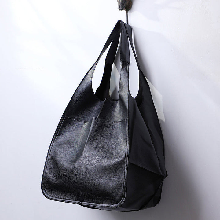 Durable red women's shoulder bag, perfect for weekend getaways.