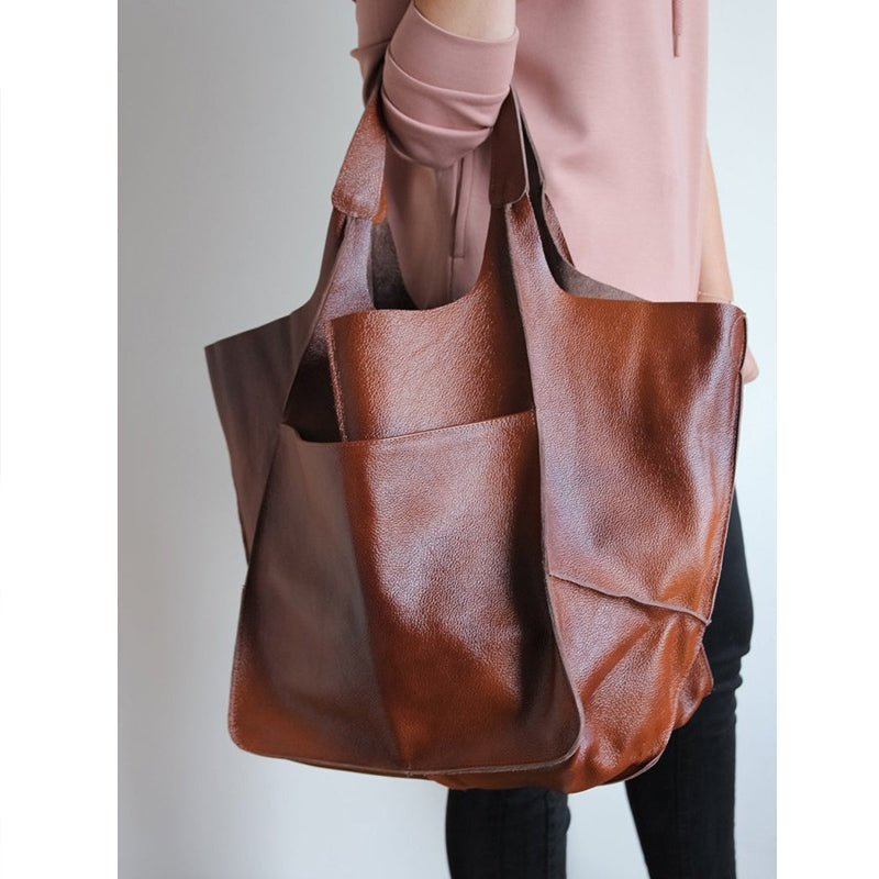 Green oversized women's travel tote, combining style and utility.