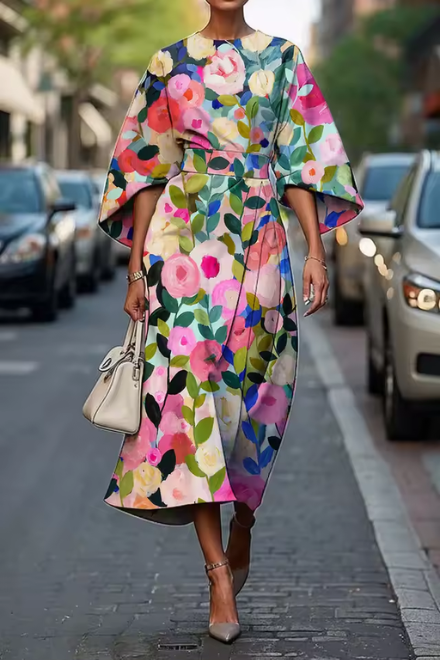 Elegant women's wedding guest midi dress. Features a beautiful painterly floral print & stylish puff sleeves.