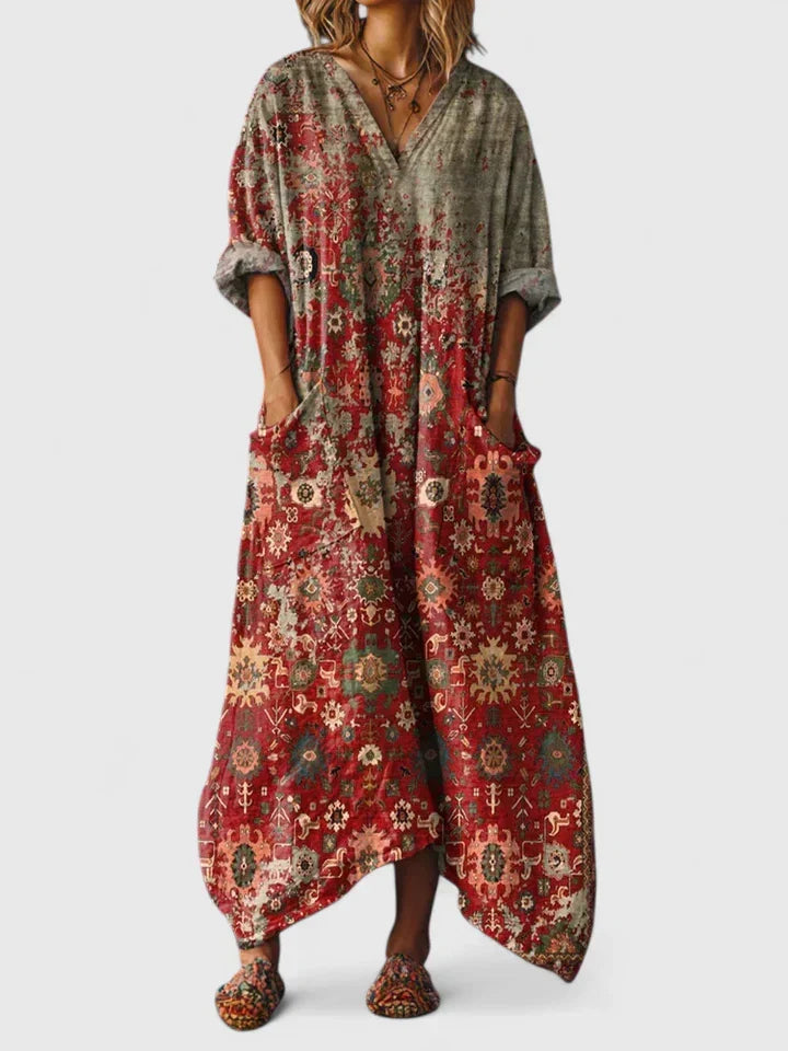 Women's paisley boho maxi dress with a relaxed v-neck, long flowy style, and practical patch pockets.