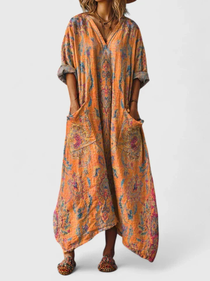Close-up of the vibrant paisley print on a women's relaxed fit boho maxi dress with a v-neck & pockets.