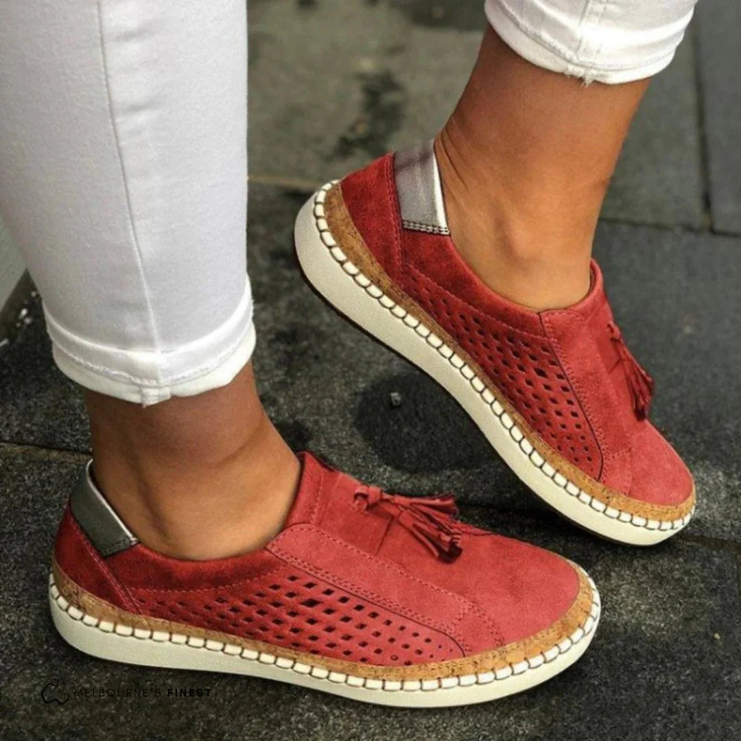 Casual women's perforated slip-on sneakers with a modern design, great for spring/summer style.
