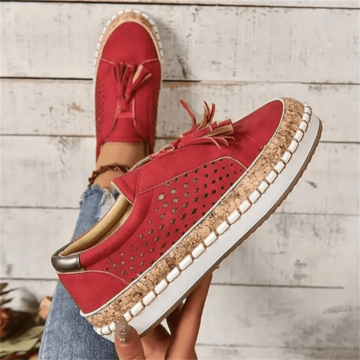 Versatile women's slip-on sneakers featuring a perforated upper, ideal for breathable casual wear.