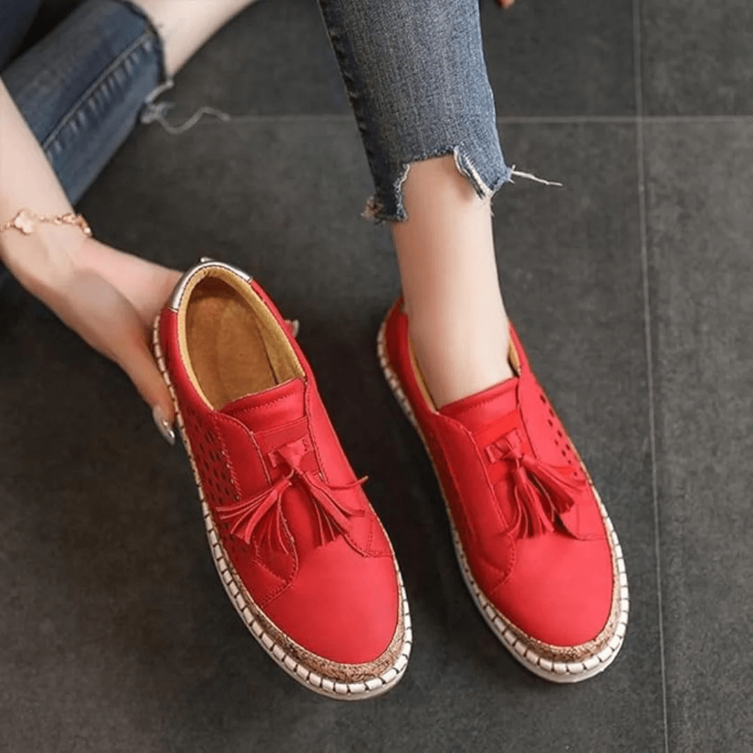 Women's perforated slip-on casual sneakers with a tassel detail, offering comfort for summer everyday.