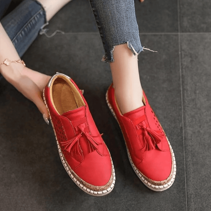 Women's perforated slip-on casual sneakers with a tassel detail, offering comfort for summer everyday.